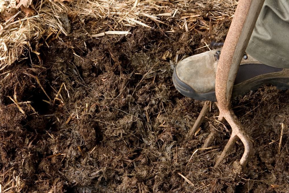 A Person Is Digging In The Dirt With A Fork — Andrew Johnston Haulage In Casino, NSW