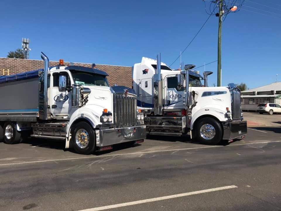 Two Semi Trucks Are Parked Next to Each Other on the Side of the Road — Andrew Johnston Haulage In Byron Bay, NSW