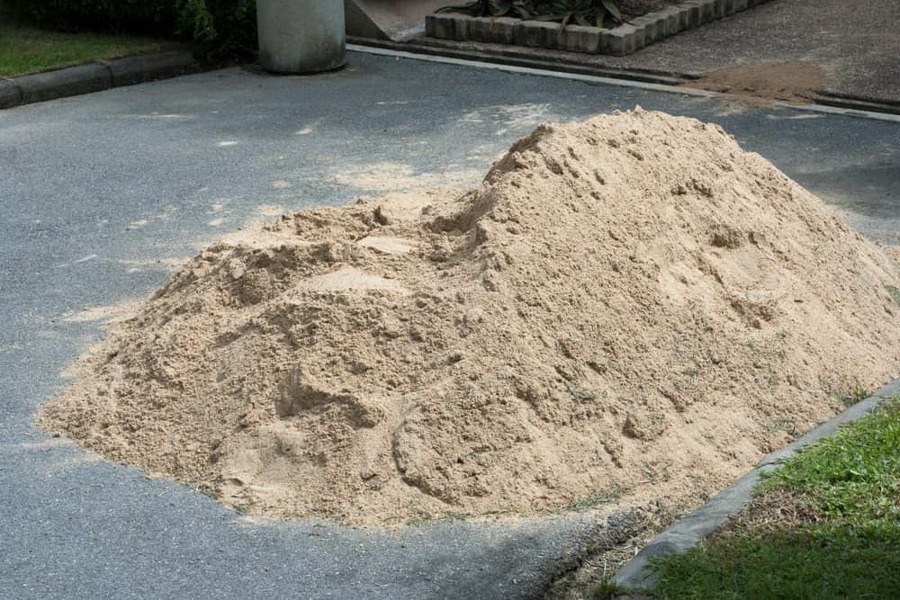 A Pile Of Sand Sits On The Side Of A Road — Andrew Johnston Haulage In Ballina, NSW