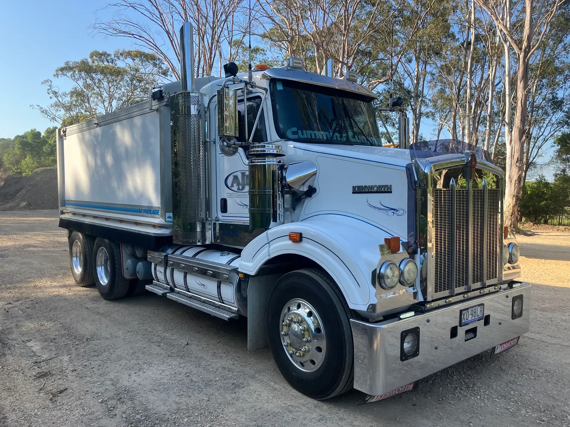 A Large White Semi Truck is Parked in a Dirt Lot — Andrew Johnston Haulage In Ewingsdale, NSW