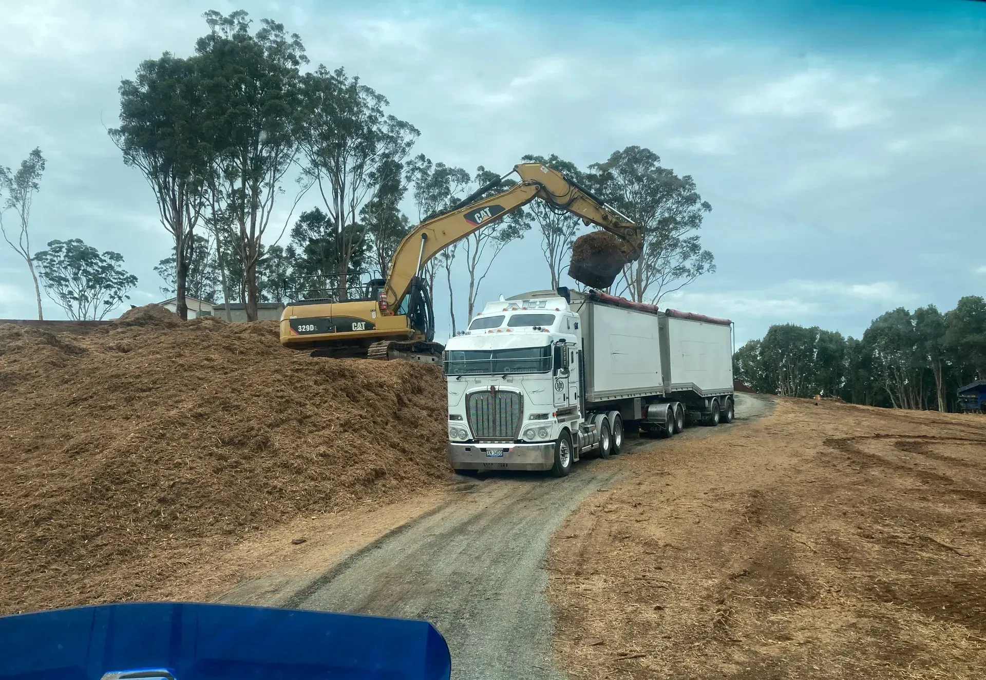 A Truck Is At A Quarry With Mulches — Andrew Johnston Haulage In Ewingsdale, NSW