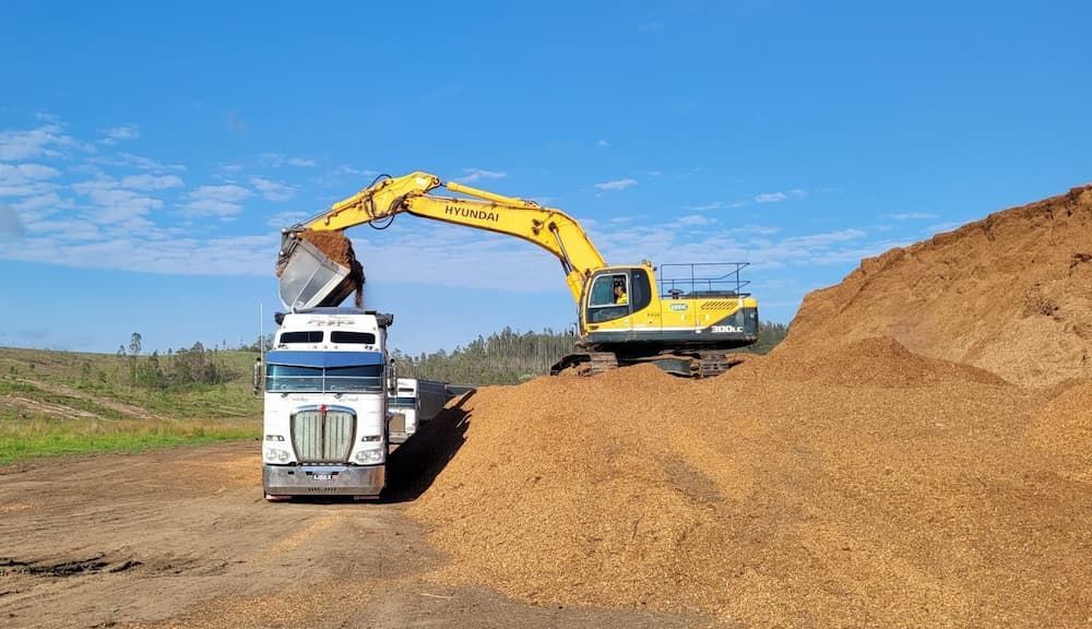 A Truck is being Loaded with Dirt by Excavator — Andrew Johnston Haulage In Ewingsdale, NSW