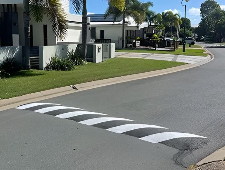 A Black And White Striped Speed Bump On The Side Of A Road — Elite Bitumen & Asphalt In Mackay, QLD