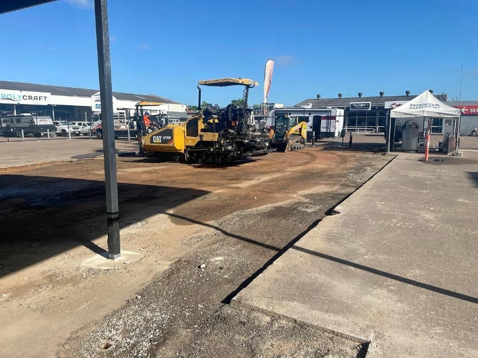 A Group Of Construction Vehicles Are Working On A Road In A Parking Lot — Elite Bitumen & Asphalt In Mackay, QLD