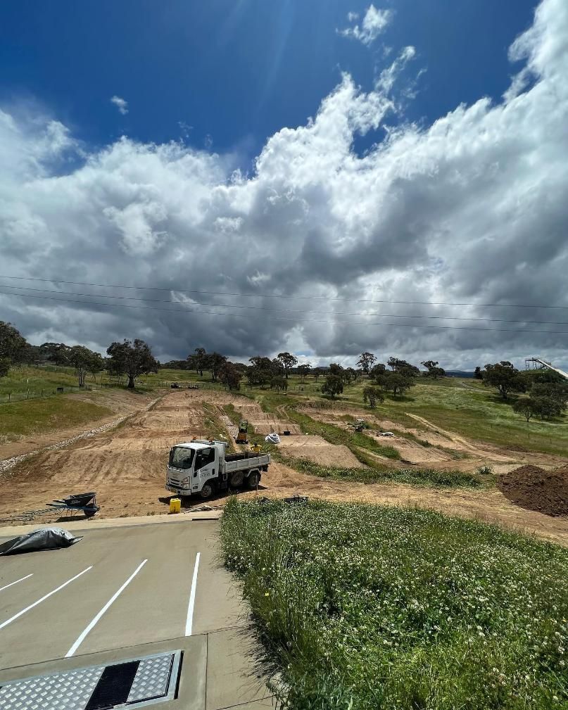 A Truck Is Parked On The Side Of A Road In A Field — Elite Bitumen & Asphalt In Mackay, QLD