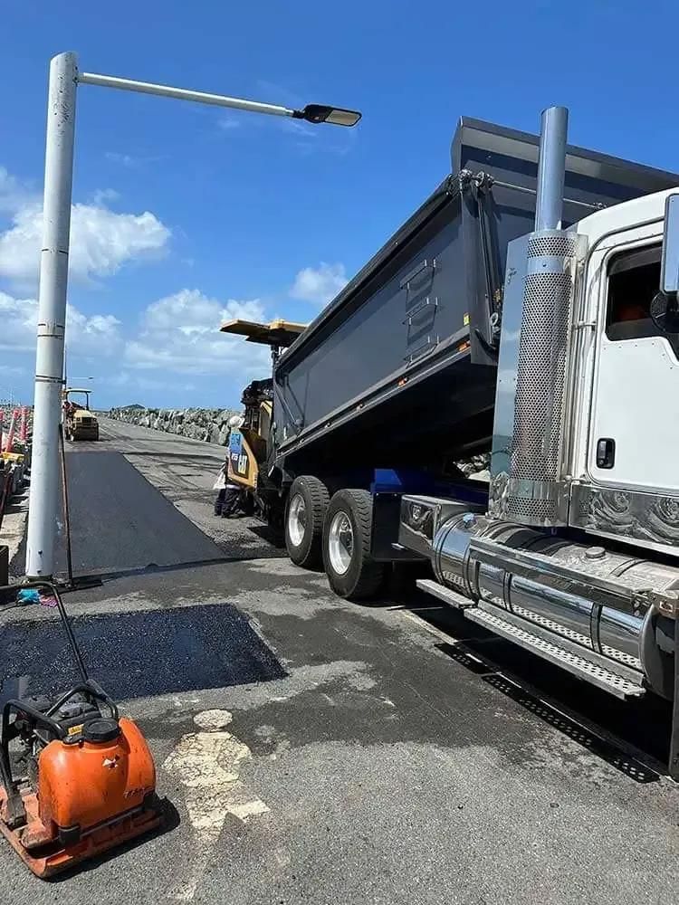 A Dump Truck Is Parked On The Side Of The Road — Elite Bitumen & Asphalt In Mackay, QLD