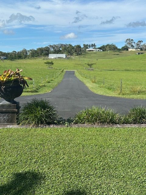 A Bitumen Driveway On A Grassy Field — Elite Bitumen & Asphalt In Moranbah, QLD