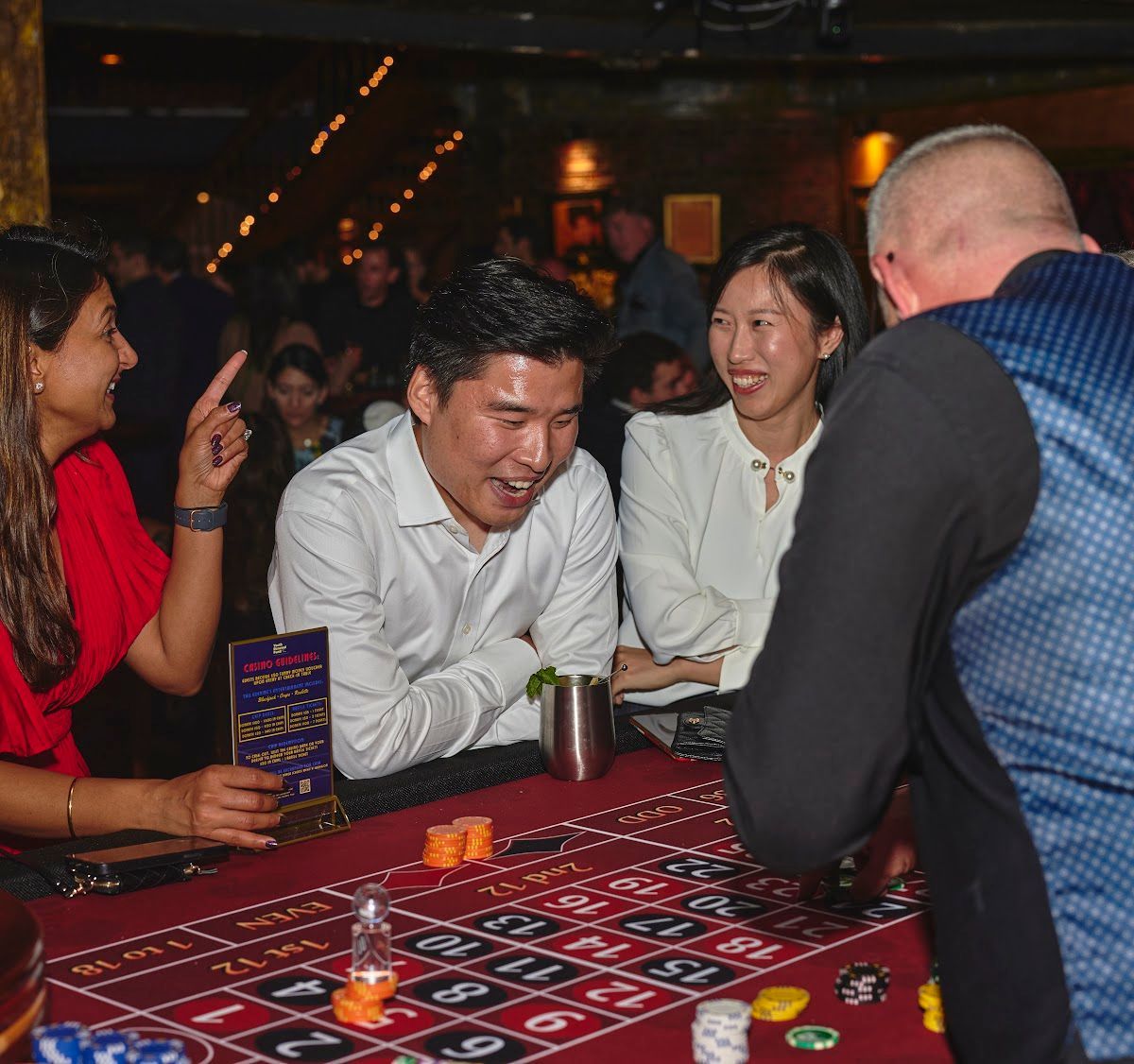 casino table with guests at a company holiday party