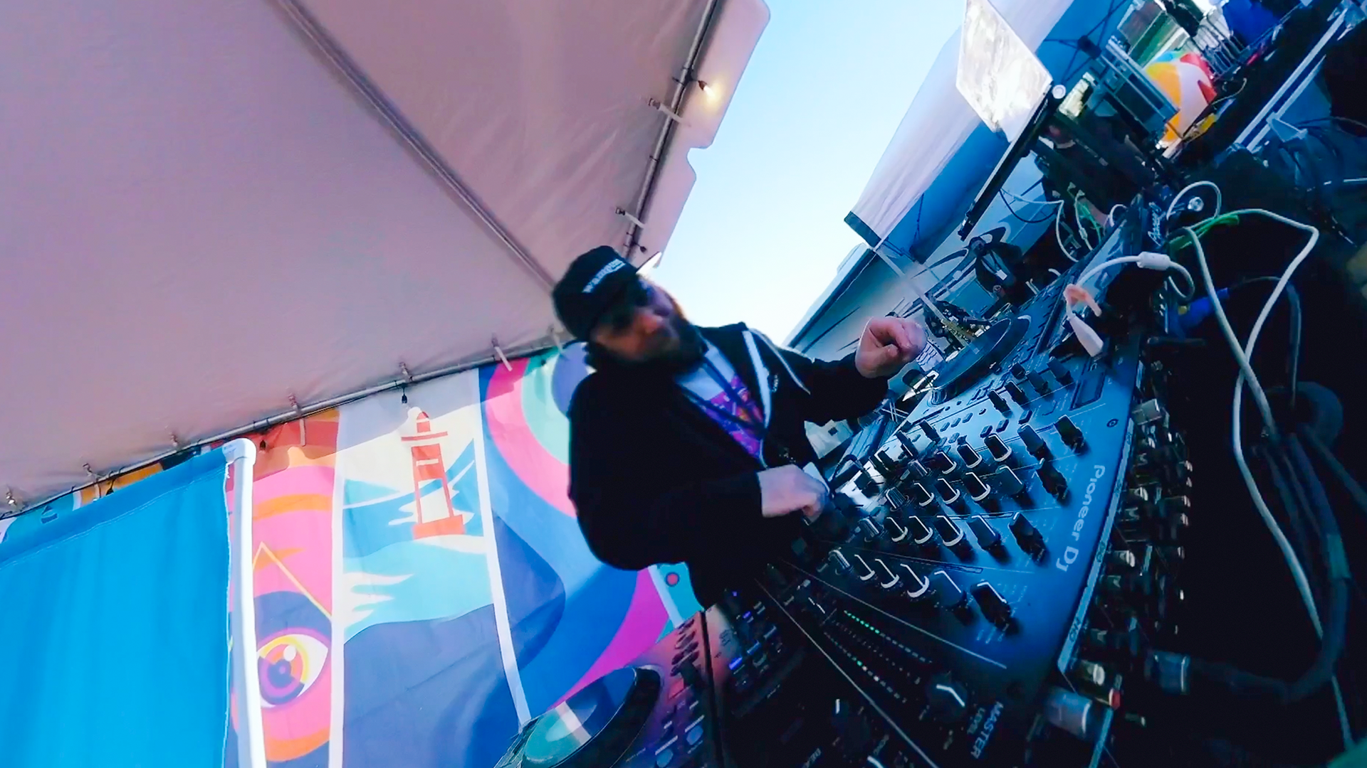 DJ Kaution performing on stage at a festival