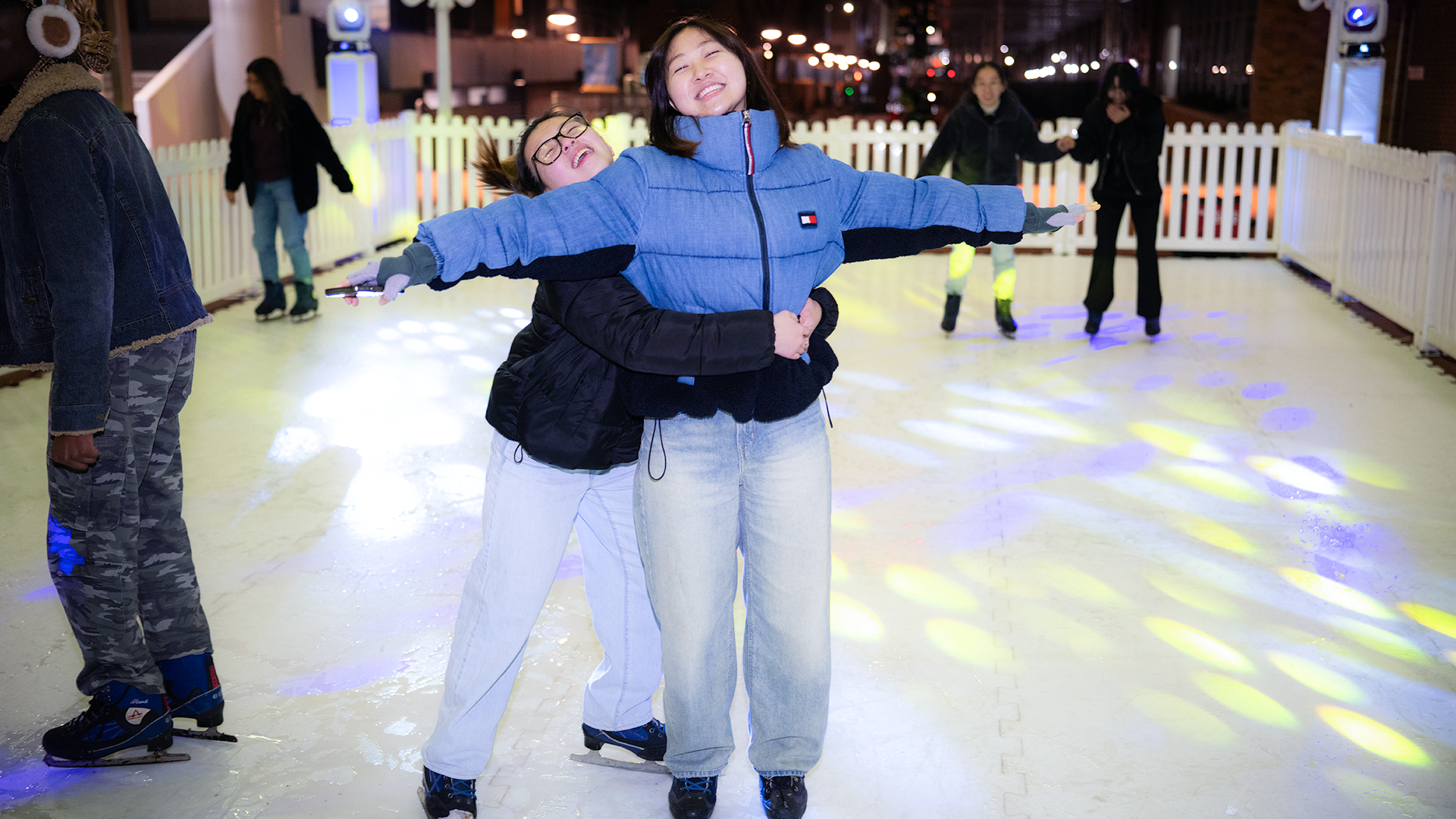 2 girls on a synthetic ice rink