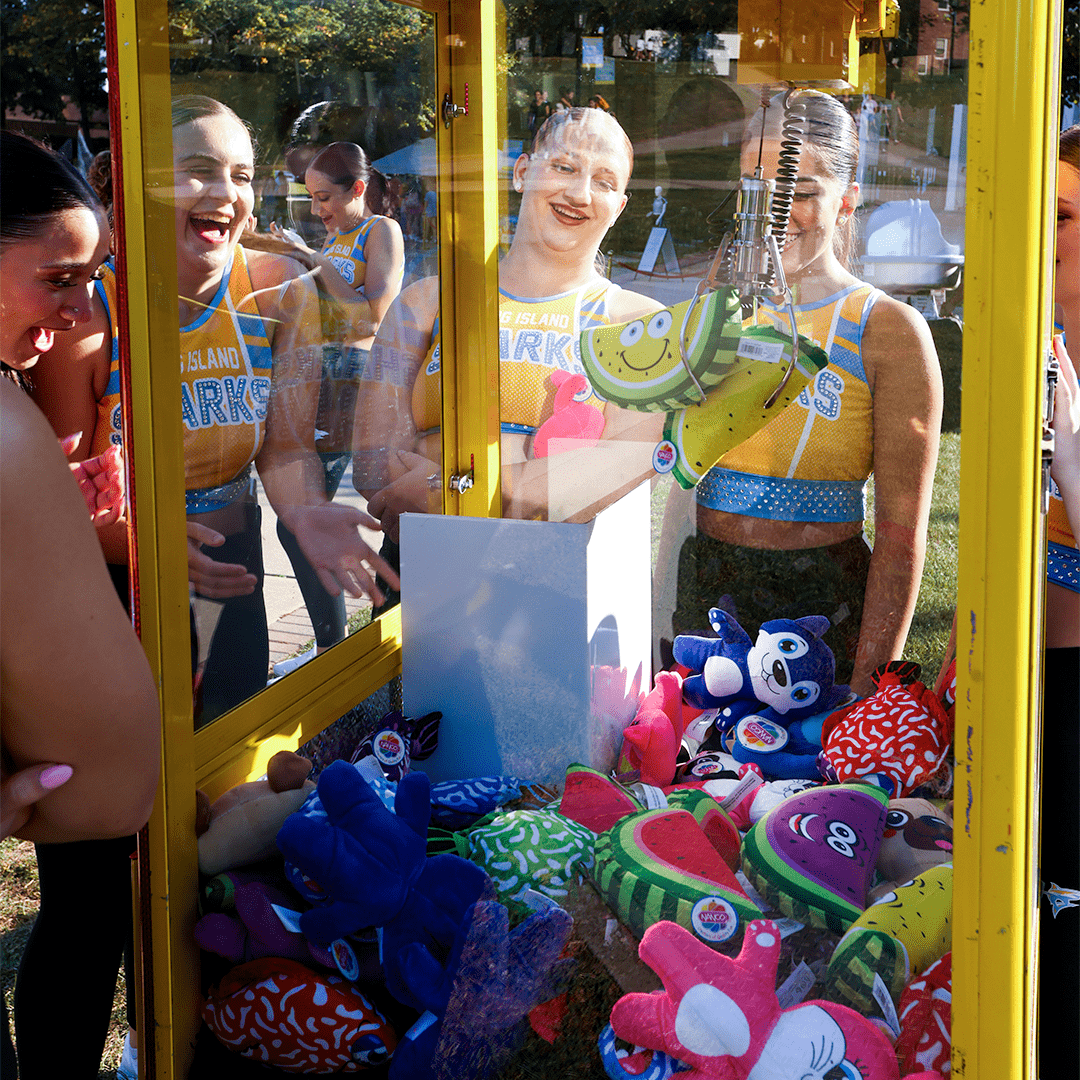 Girls playing with a claw machine game
