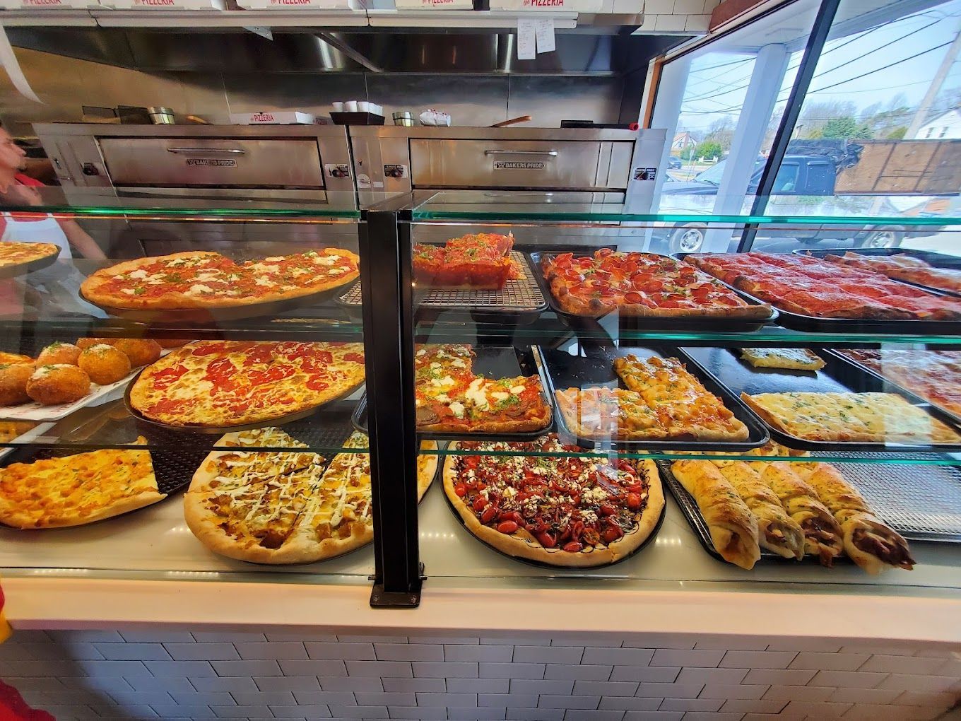 Enjoy fresh pizzas & diverse menu at The Pizzeria in Bayport. 