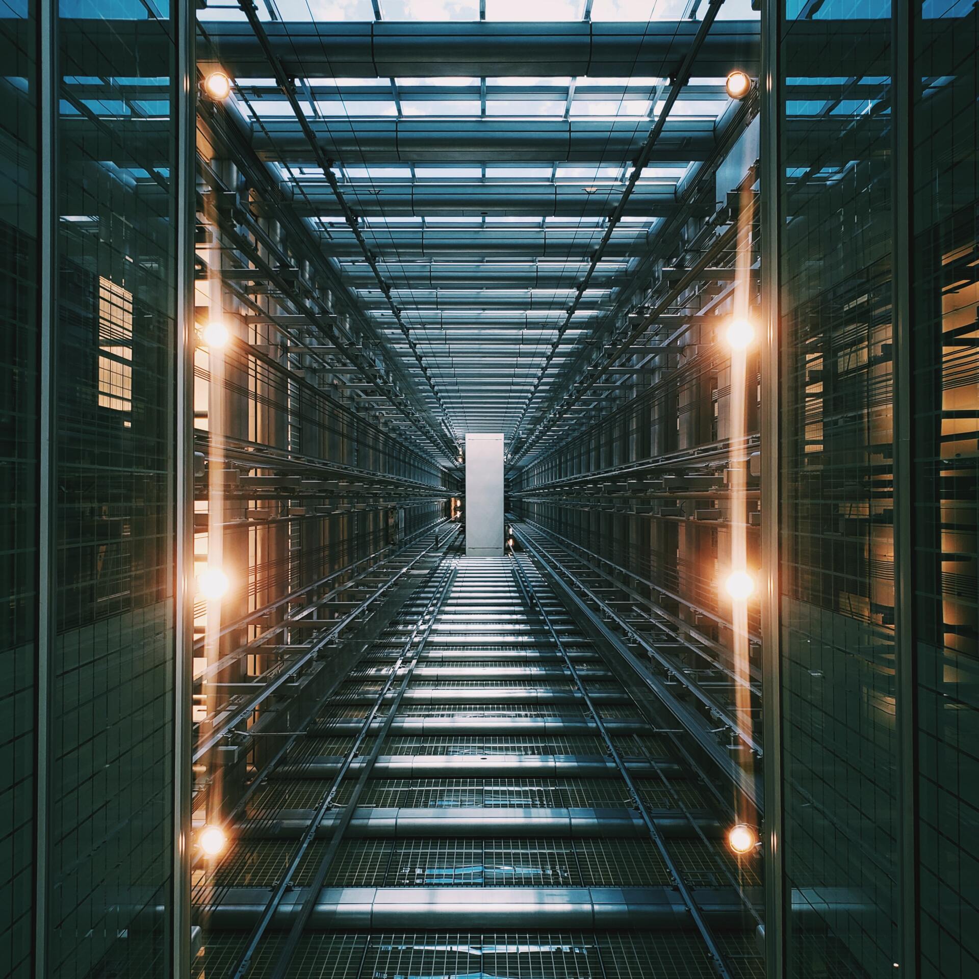 A long hallway with stairs and lights on the walls