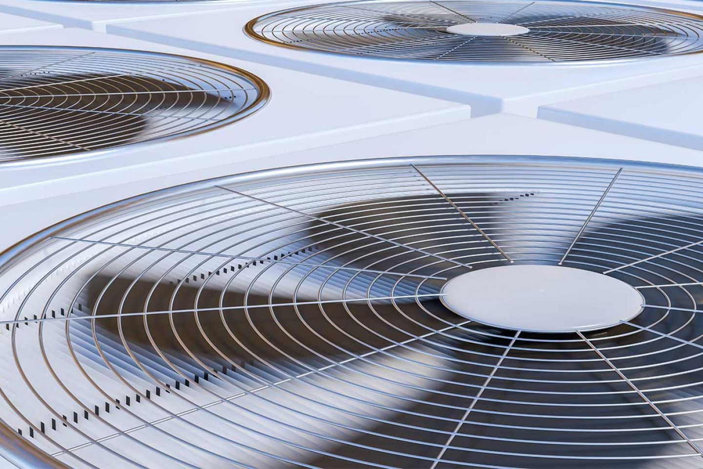 Close-up of several metallic air conditioning fan units arranged in a grid.