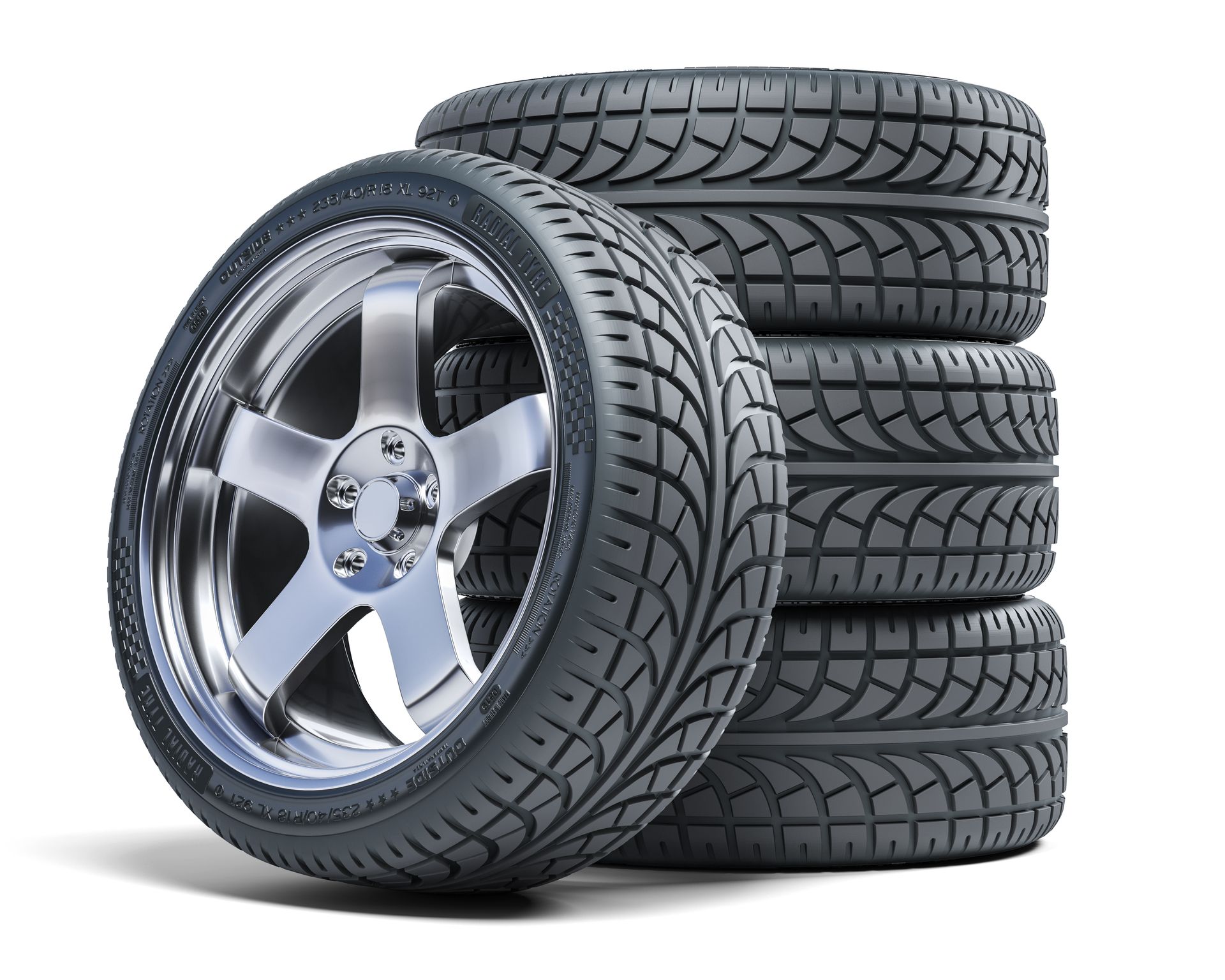 A car tire with a chrome rim next to a stack of four tires on a white surface.
