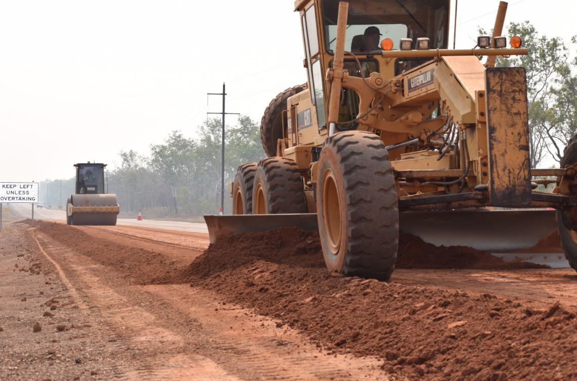 A Bulldozer Is Engaged In Tasks On A Dirt Road — Coleman's Contracting & Earthmoving In Humpty Doo, NT