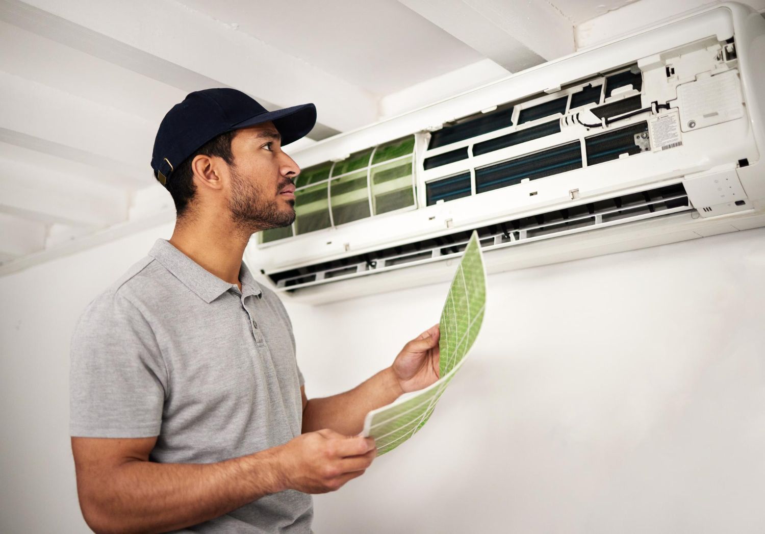 Air conditioning units on a rooftop. White metal boxes with vents and fans.