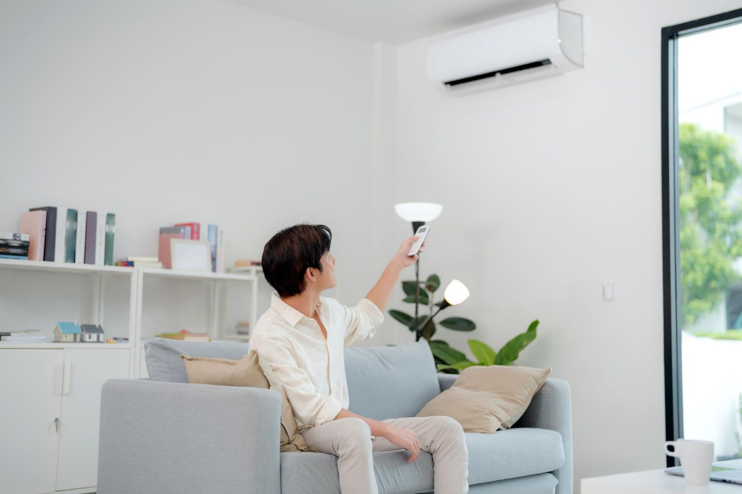 Air conditioning units on a rooftop. White metal boxes with vents and fans.