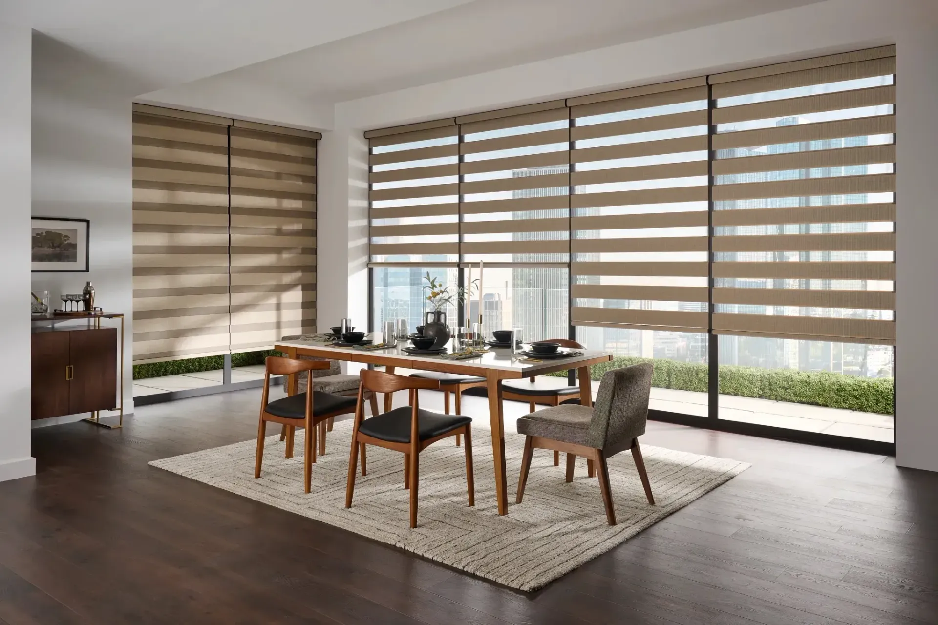 Dining room with modern blinds, dining table, chairs, and area rug.