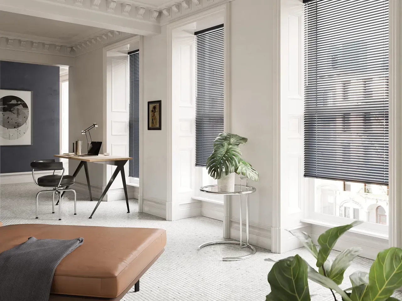 Interior room with brown chaise lounge, desk, plants, and venetian blinds.