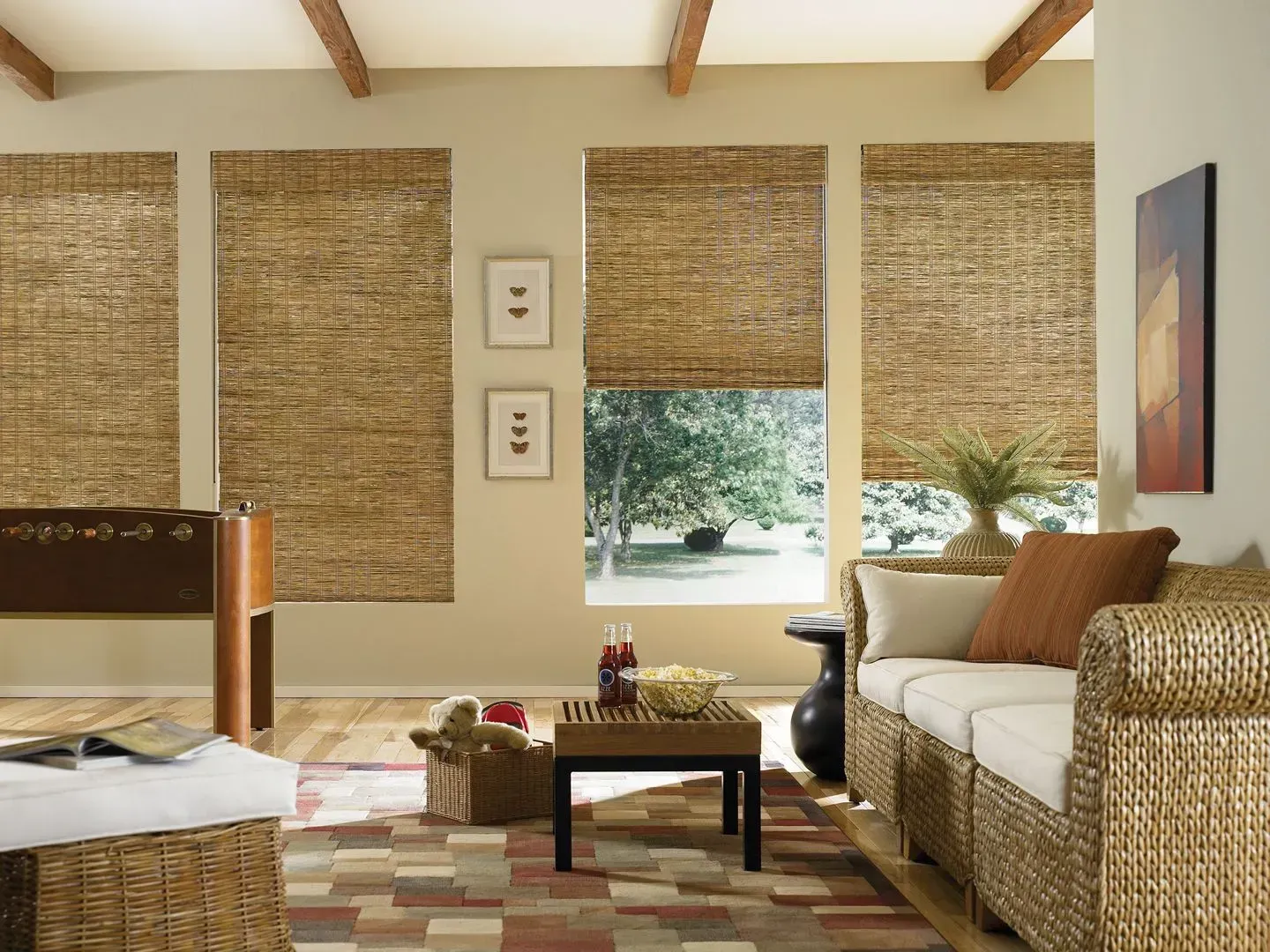 Living room with woven shades, light walls, and beige woven furniture.