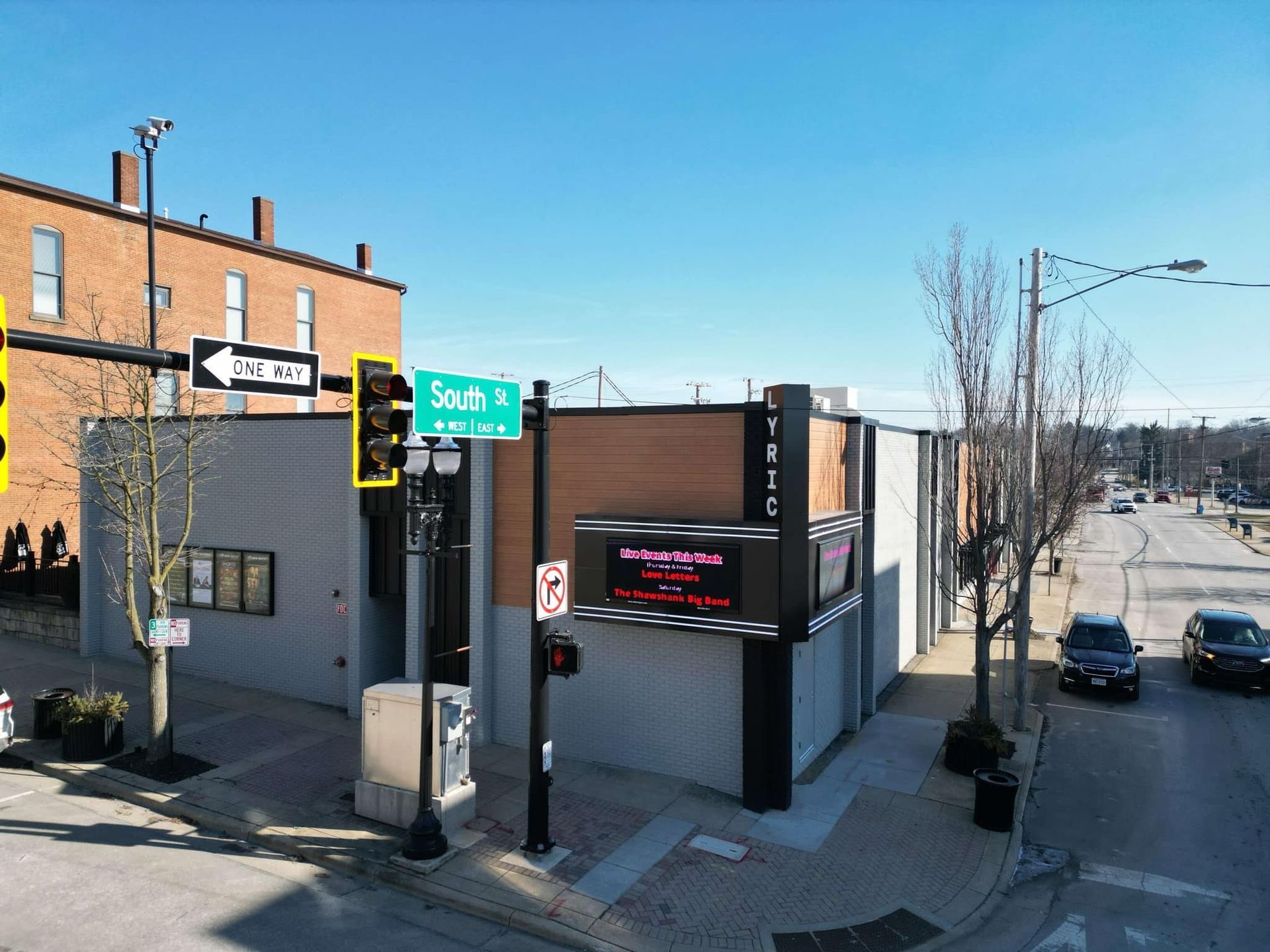 Exterior view of a building on a corner. A street sign reads
