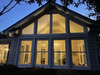 House exterior with glowing windows at dusk.