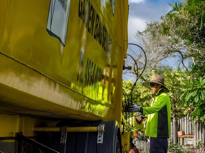 Garbage Truck Worker in High-Vis Vest Operates — Bobs Bags & Bins in Mackay, QLD