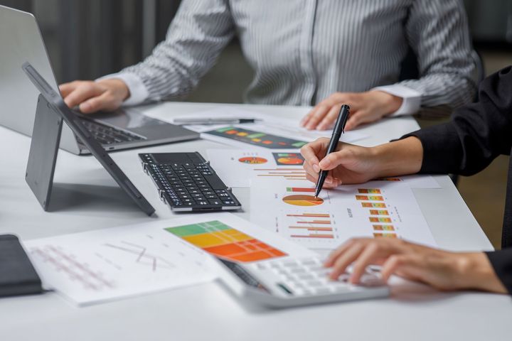 Image of person studying a presentation with graphs