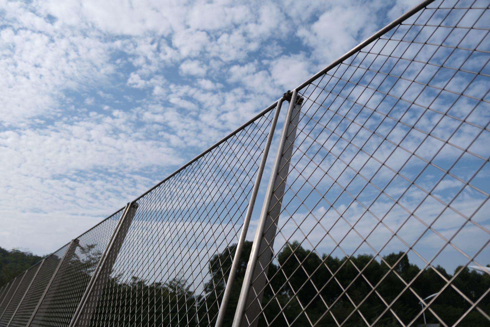 Dark, horizontally ridged metal wall with vertical white supports, angled perspective.