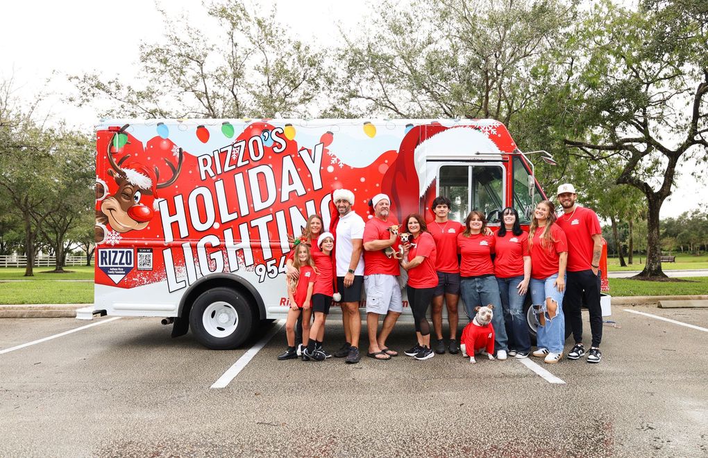 Rizzo's holiday lighting company photo with work truck in background