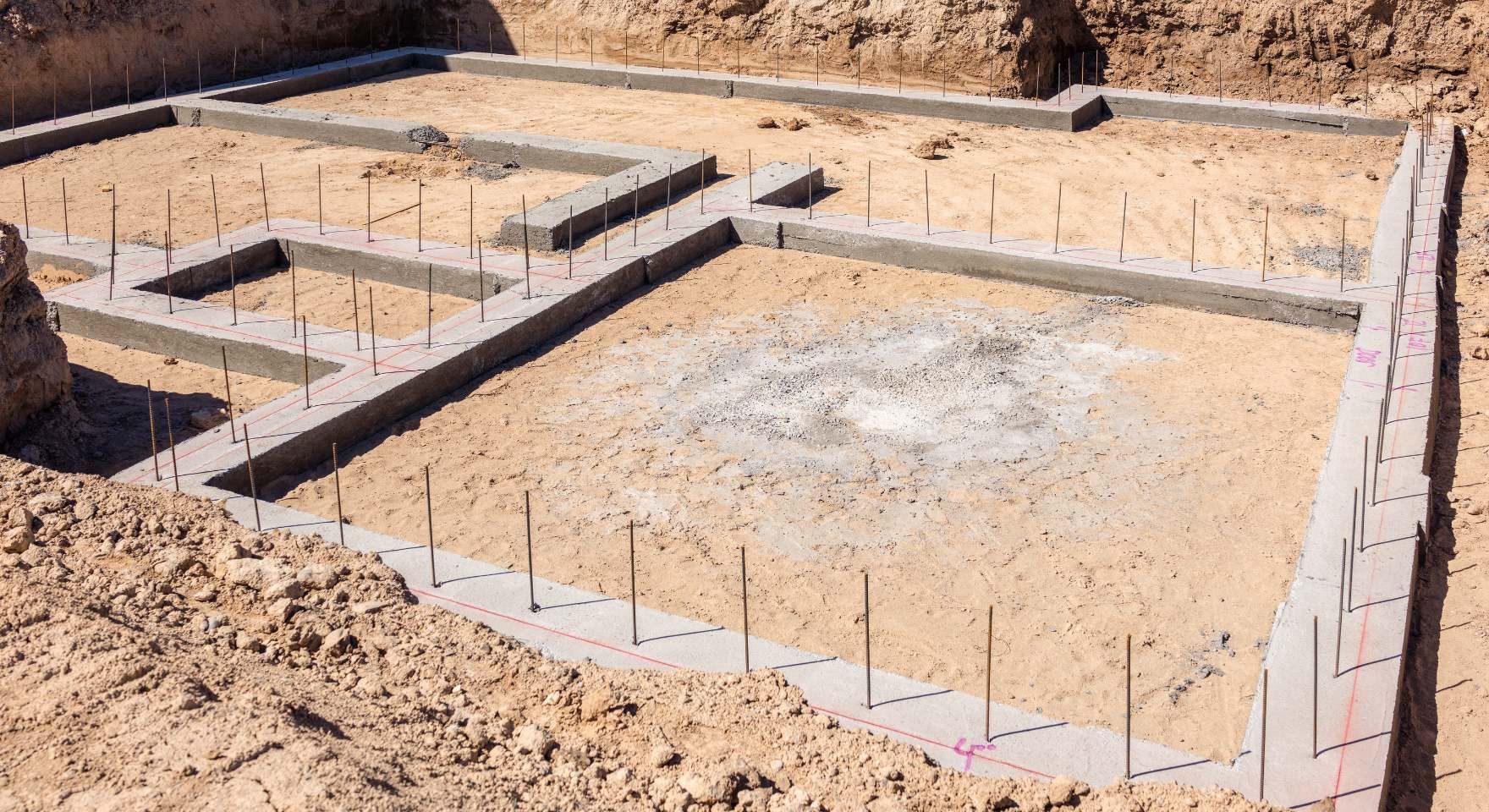 Prepared foundation base with compacted soil and layout lines before block wall construction during a block and retaining wall service in Santa Ana, CA