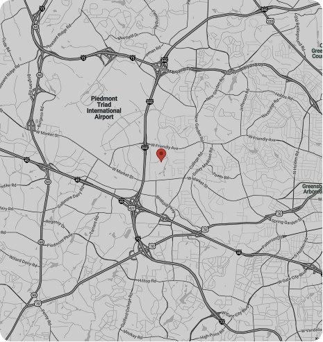 Road map with a red location pin near the center and a marked point of interest on the left.