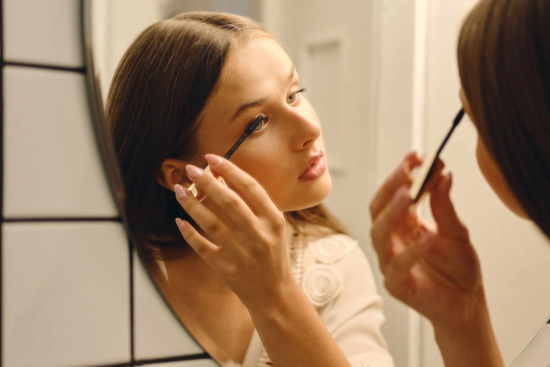 brushing lash extensions using a clean mascara wand