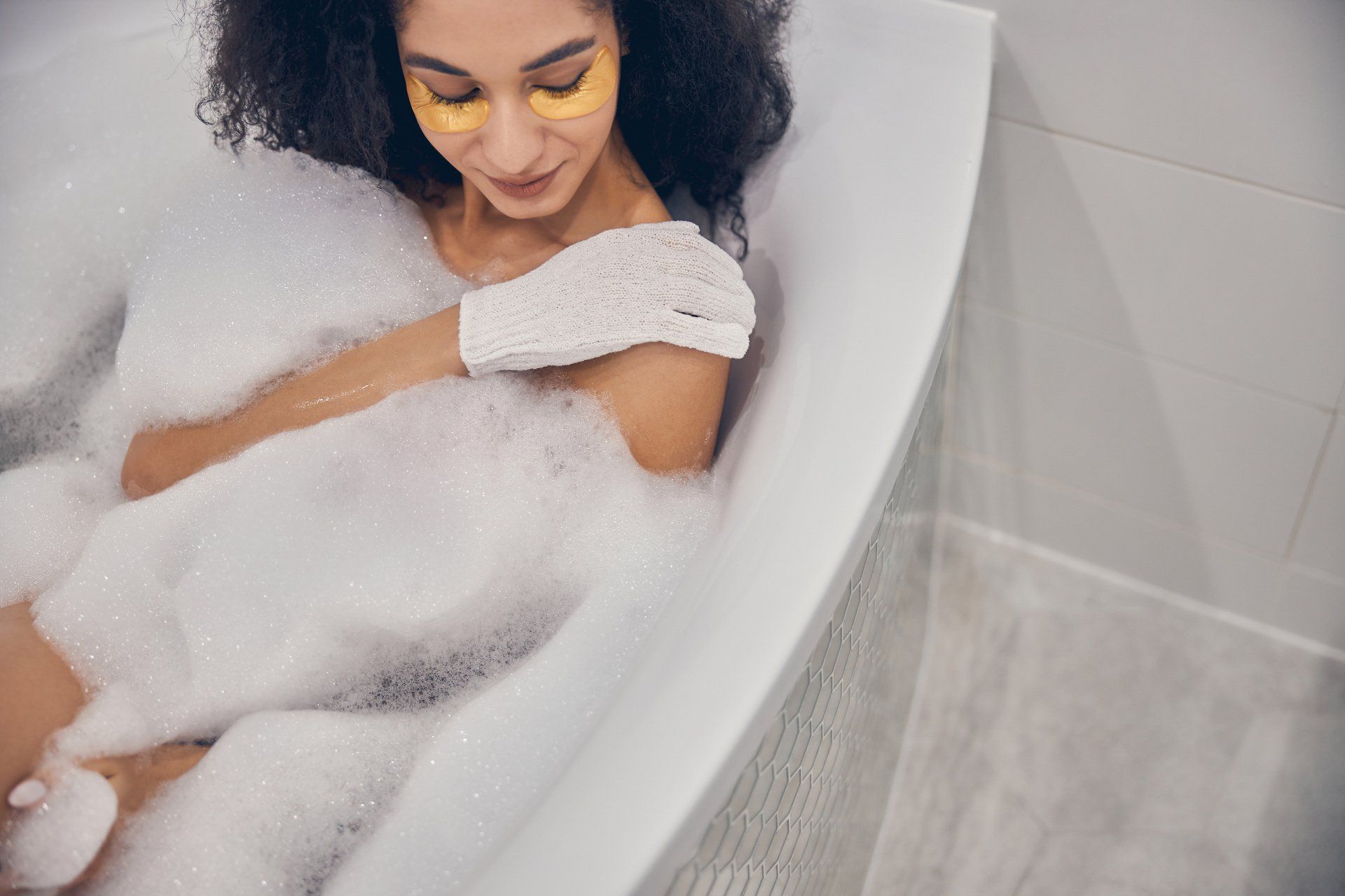 young woman using an exfoliating glove