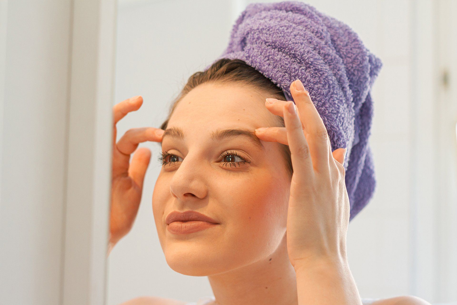 woman cleansing her face