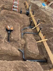 A ladder is sitting on top of a pile of dirt.