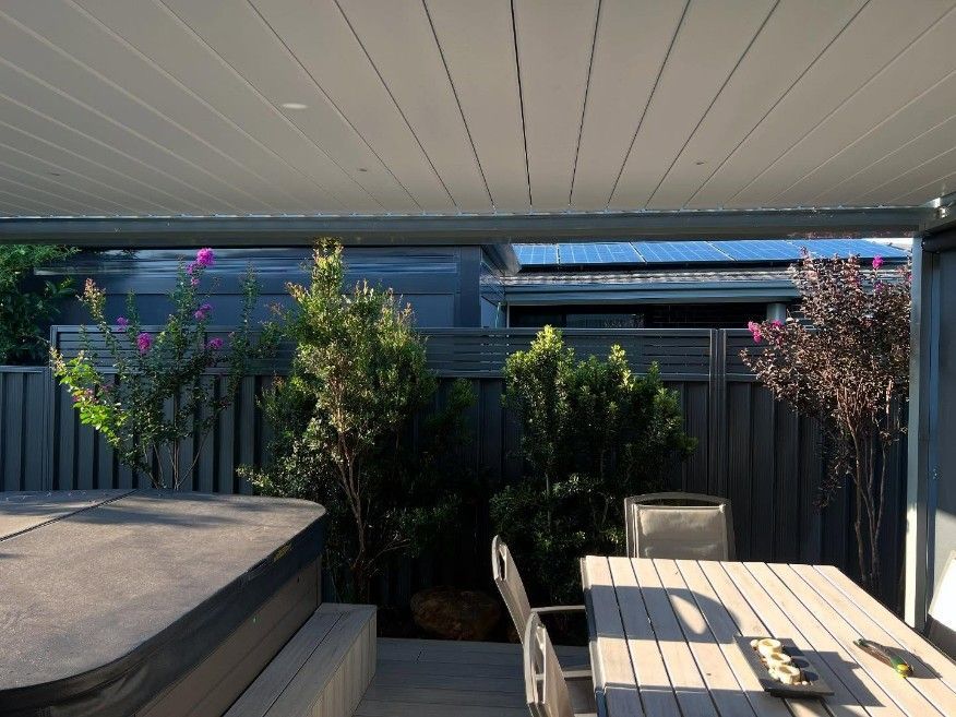 A Patio With a Table and Chairs and a Hot Tub — JOA - JOA - Construction & Maintenance Pty Ltd in Appin, NSW