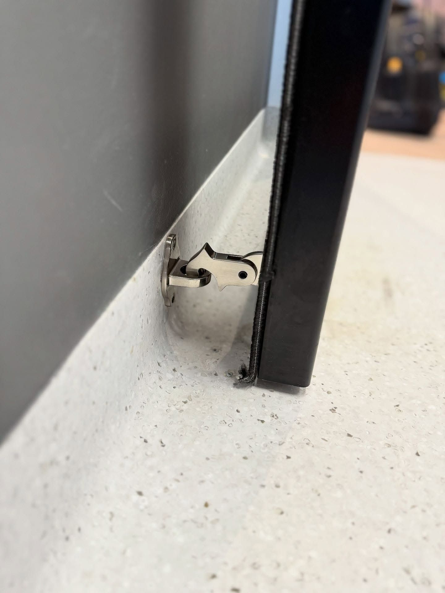 A Black Door is Sitting on a White Floor Next to a Wall — JOA - Construction & Maintenance Pty Ltd in Wollongong, NSW