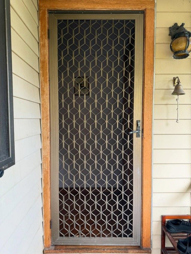A Door With a Geometric Pattern on It — JOA - Construction & Maintenance Pty Ltd in Thirlmere, NSW