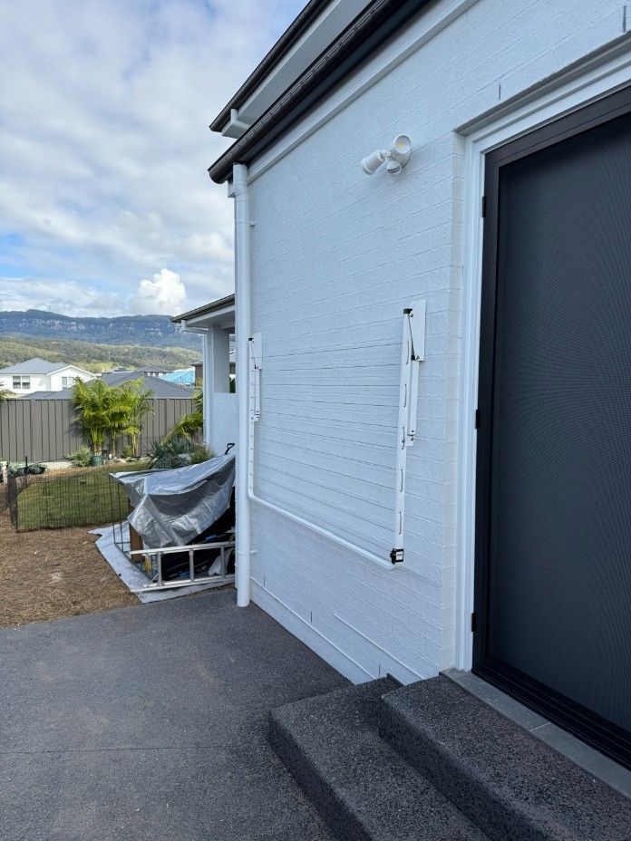 A White House With a Black Door and Stairs — JOA - Construction & Maintenance Pty Ltd in Appin, NSW