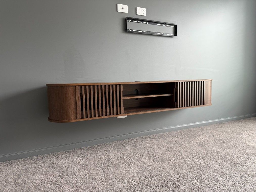 A Wooden Entertainment Center is Hanging on a Wall in a Living Room — JOA - Construction & Maintenance Pty Ltd in Appin, NSW