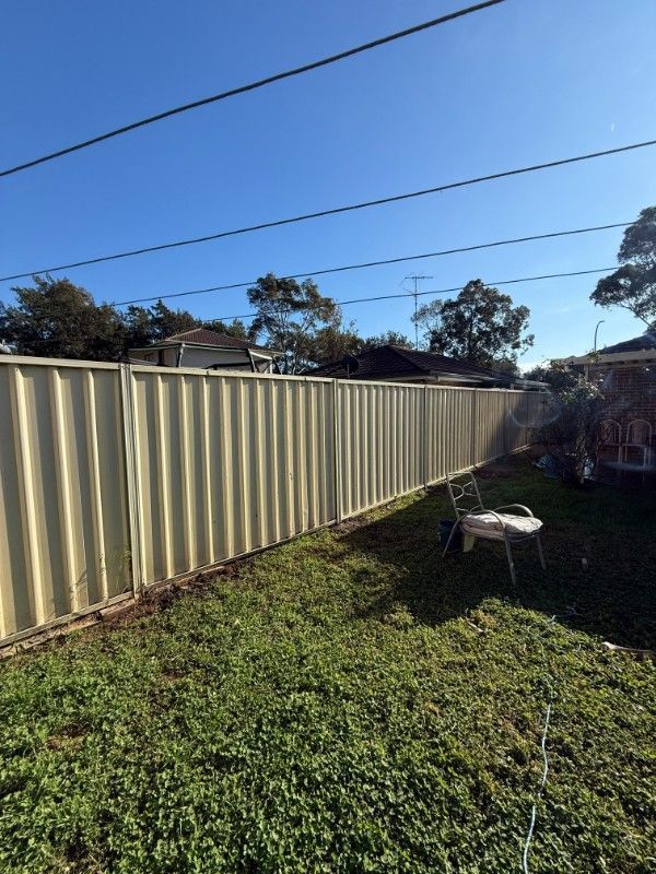 A Yard With a Fence and a Wheelbarrow in It — JOA - Construction & Maintenance Pty Ltd in Appin, NSW