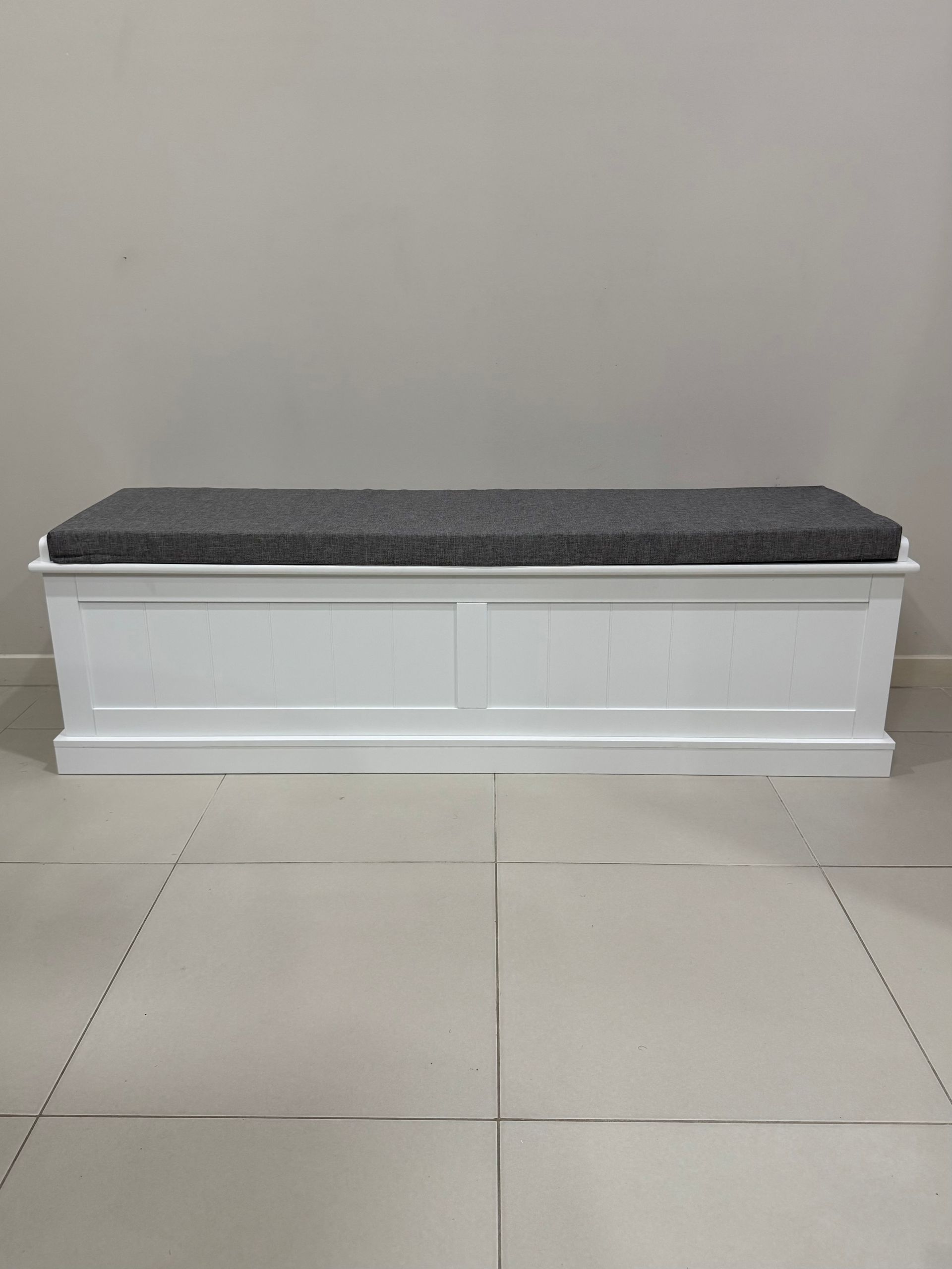 A White Bench with A Grey Cushion Is Sitting on A Tiled Floor. — JOA - Construction & Maintenance Pty Ltd in Campbelltown, NSW