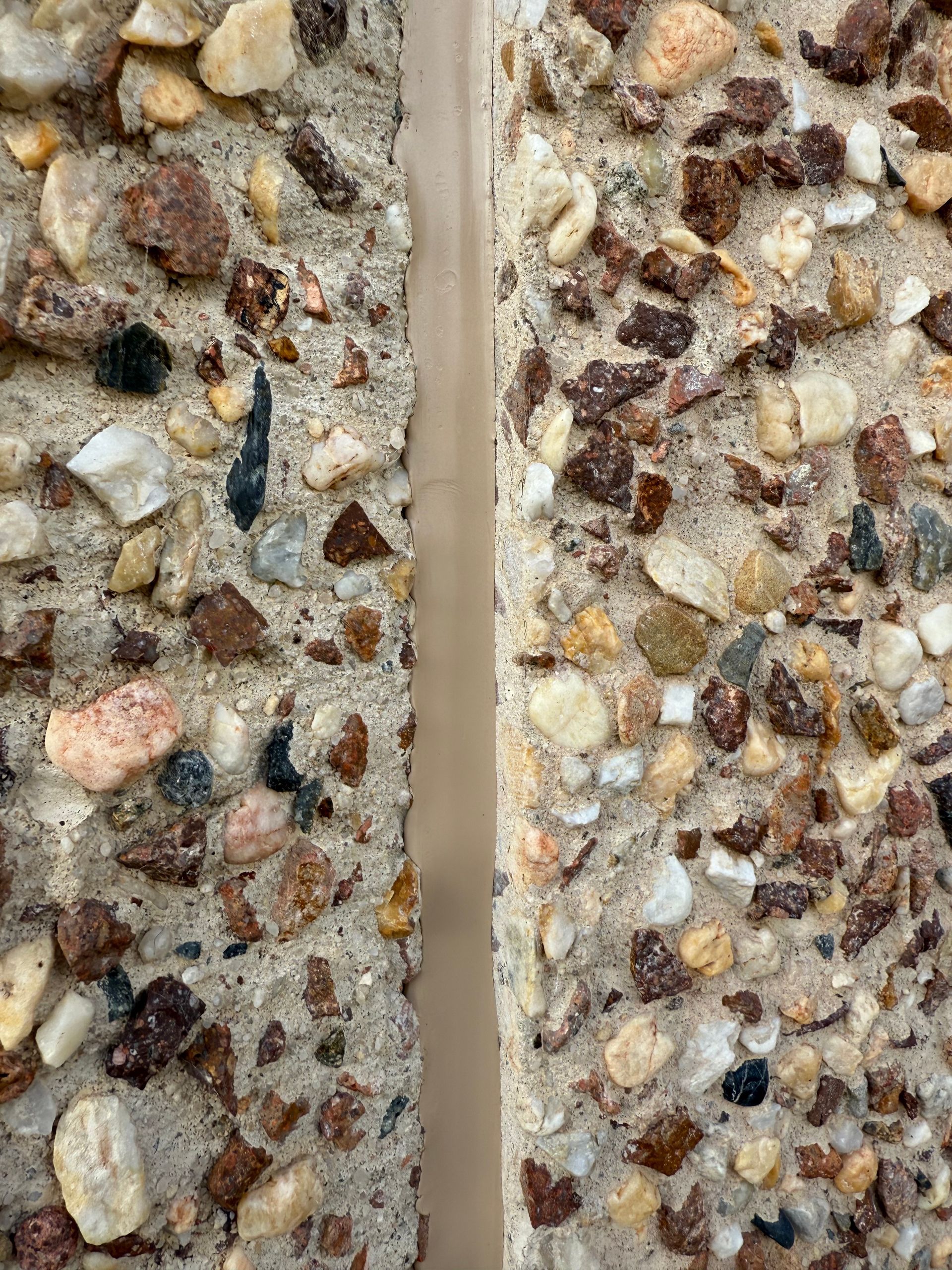 A close up of two pieces of concrete with rocks on them. — JOA - Construction & Maintenance Pty Ltd in Appin, NSW
