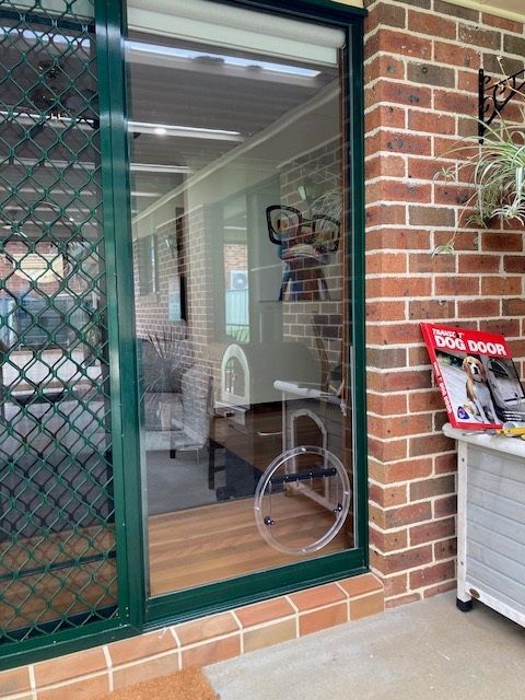 A Sliding Glass Door With a Clear Plastic Circle on It — Canobolas Glass Service In Orange, NSW