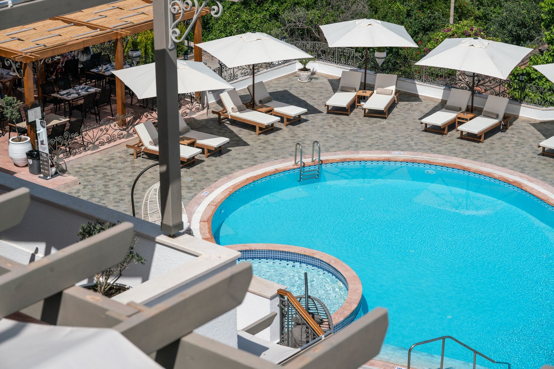  Elemanta Boutique Hotel |  Outdoor resort pool with turquoise water, white umbrellas