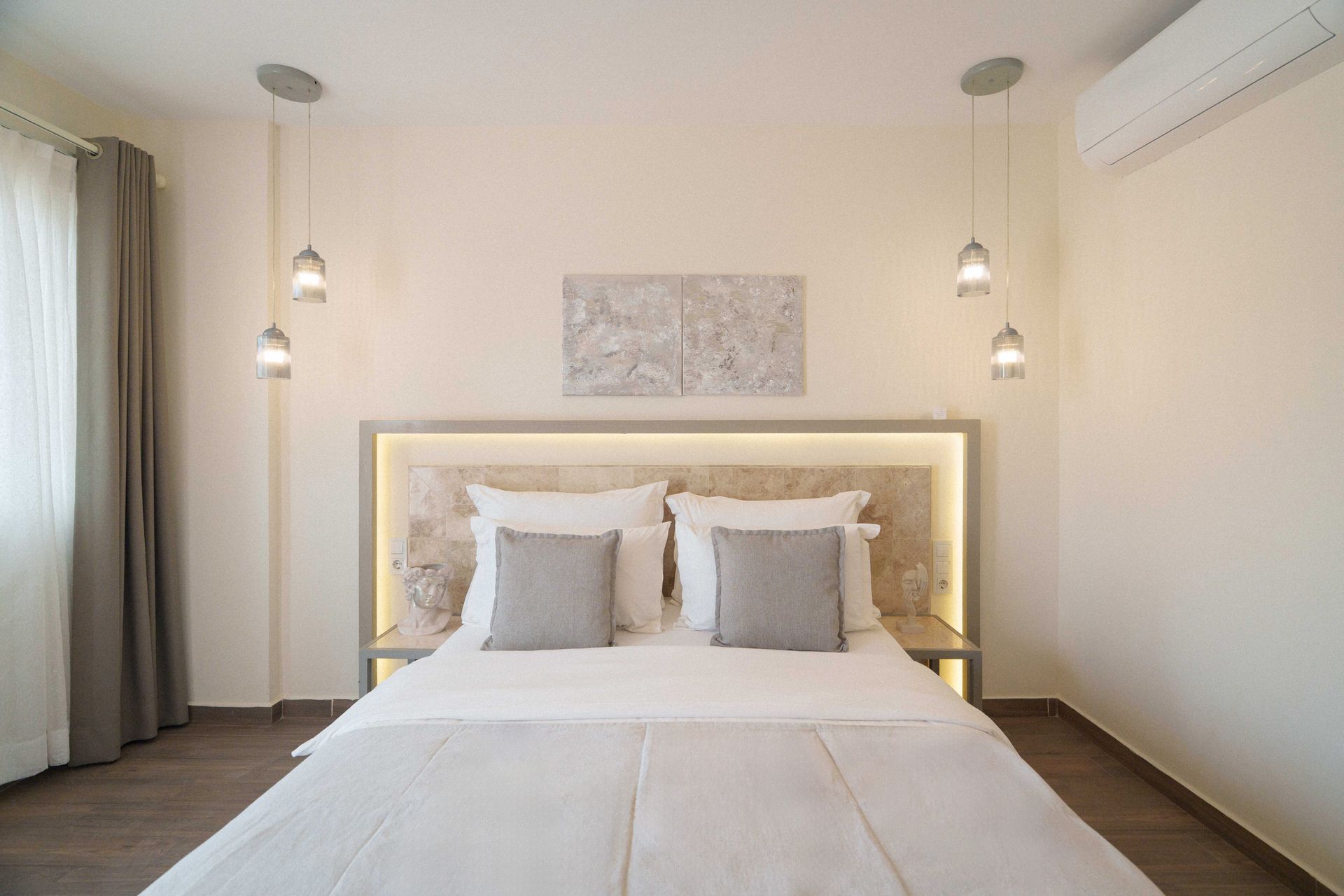 Elemanta Boutique Hotel | Bright modern bedroom with a neatly made bed, soft pendant lights, and neutral decor