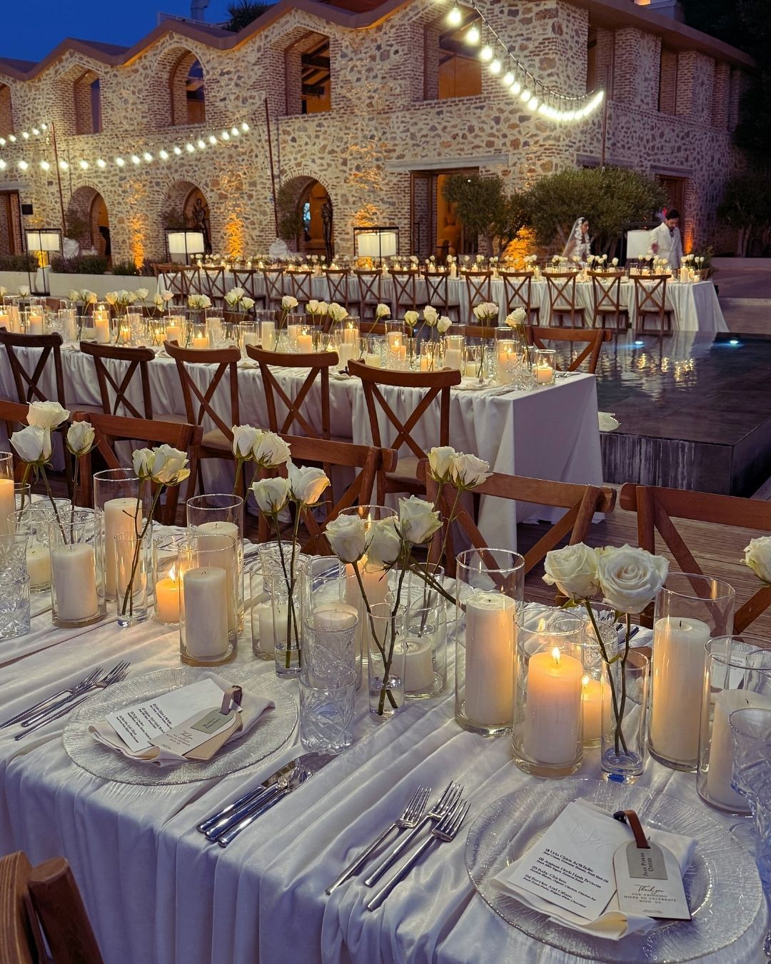 Elemanta Boutique Hotel | Elegant outdoor banquet setup with candlelit tables and floral decor in front of a stone building