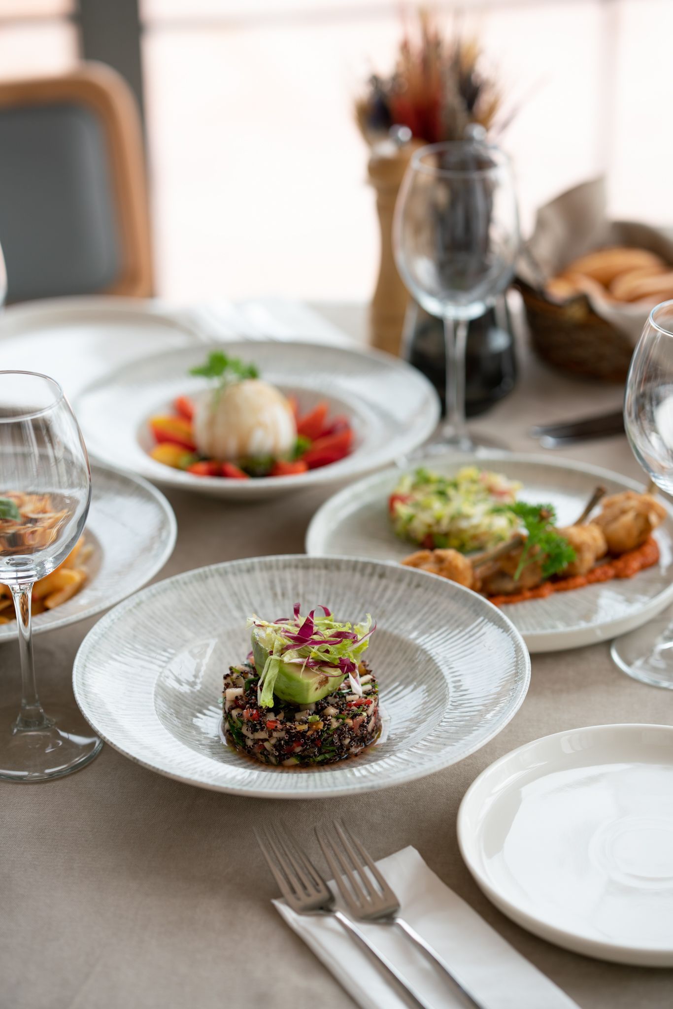  Elemanta Boutique Hotel |  Elegant dining table set with plated gourmet dishes, wine glasses